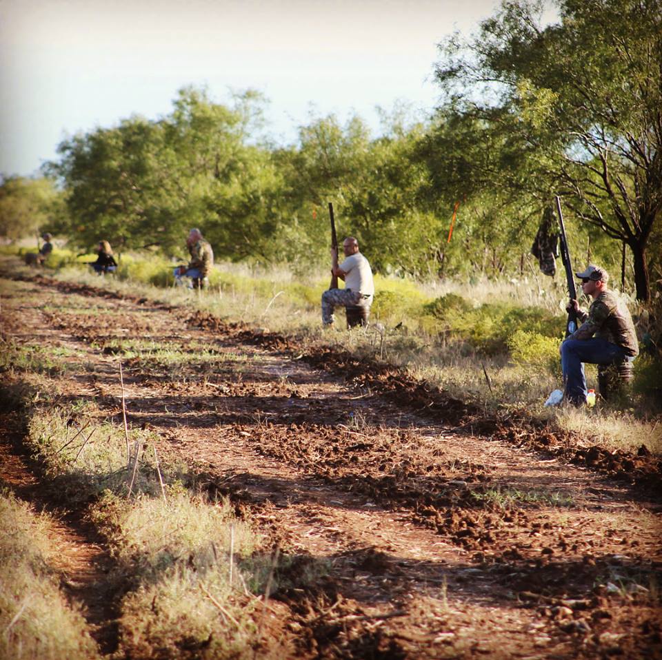 A line of hunters in a field