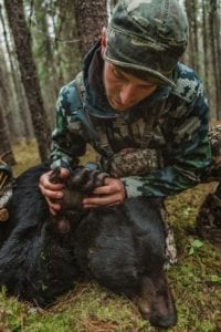 A hunter checking out his bear