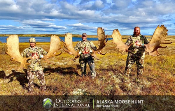 A group of extremely happy moose hunters