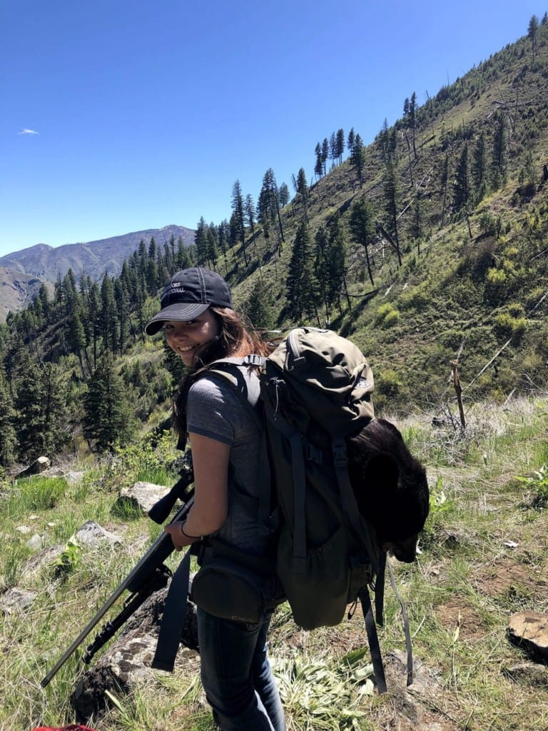 Braiden Glauner packing out her her first black bear.